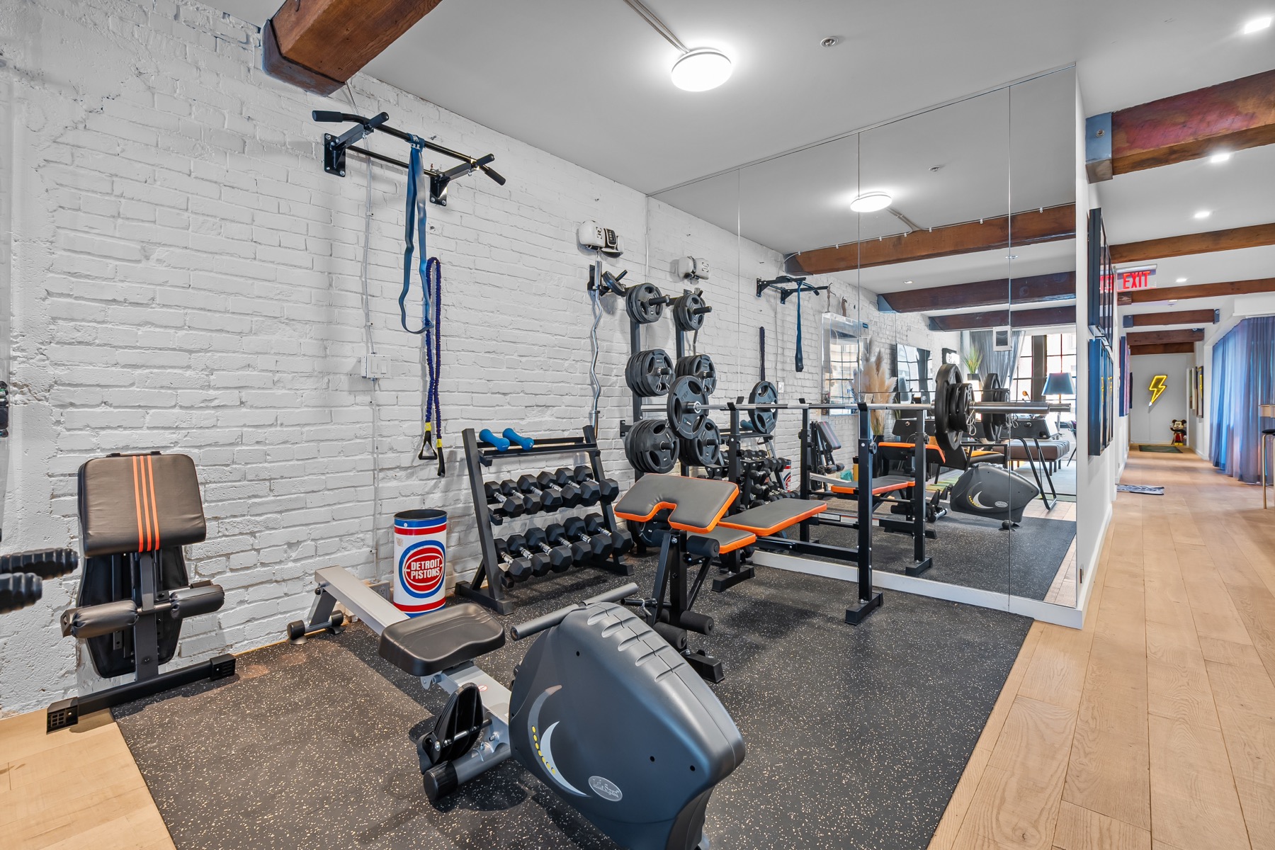 Private gym with weights, dumbbells, bench, mirror and pull-up bar
